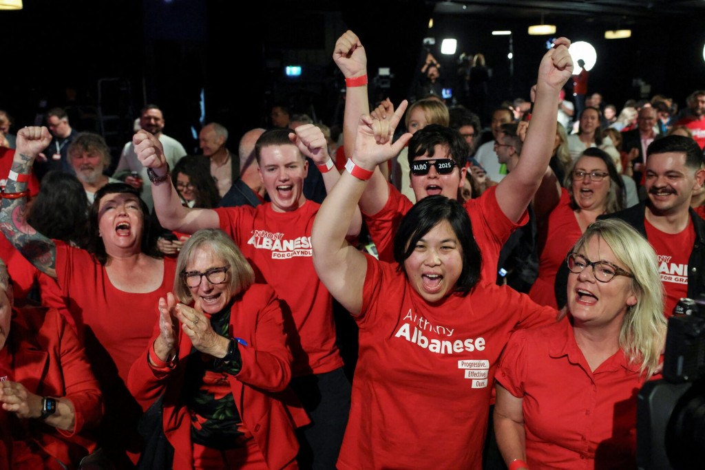 Supporters of Australia's Prime Minister Anthony Albanese react at a Labor party election night event, after local media projected the Labor Party's victory, on the day of the Australian federal election, in Sydney, Australia, May 3, 2025. REUTERS/Hollie Adams