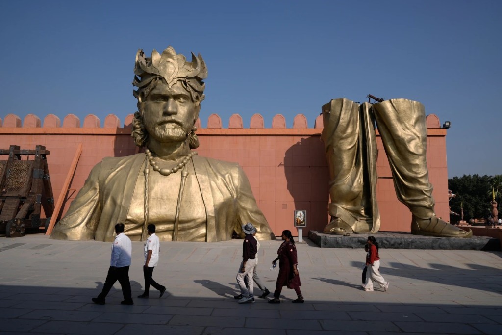 Visitors walk past the set of Bahubali in Ramoji Film City, in Hyderabad, India, Tuesday, Nov. 18, 2025. (AP Photo/Mahesh Kumar A.)