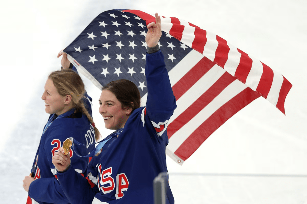 Milano Cortina 2026 Olympics - Ice Hockey - Women's Victory Ceremony - Milano Santagiulia Ice Hockey Arena, Milan, Italy - February 19, 2026. Hilary Knight and Kendall Coyne of United States celebrate with their national flag and gold medals during the ceremony REUTERS/Mike Segar
