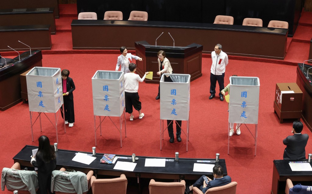 Members of Taiwan's opposition parties 'KMT' and 'Taiwan People's Party' vote on an impeachment motion against President Lai Ching-te at Legislative Yuan chamber in Taipei on May 19, 2026. (Photo by I-Hwa Cheng / AFP)