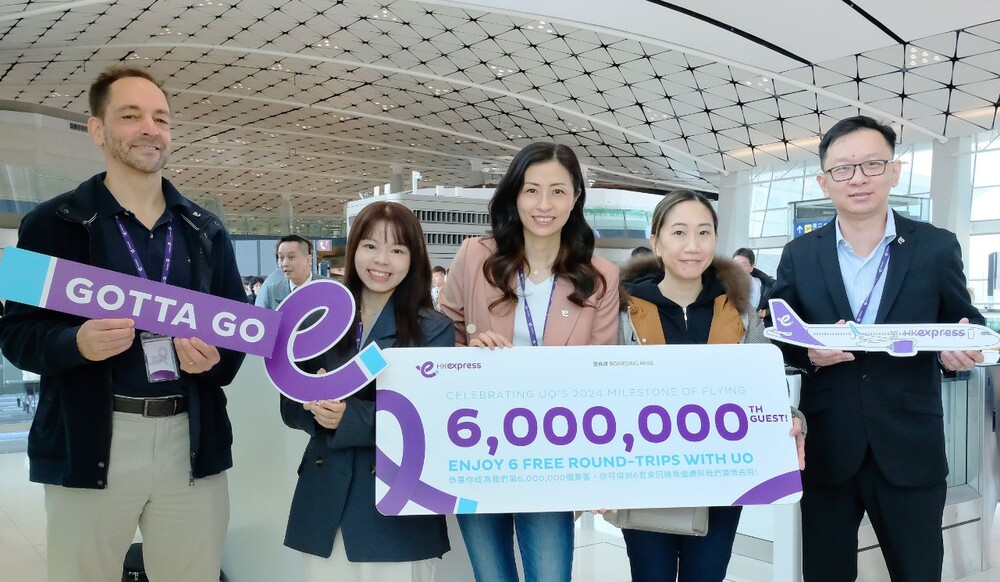 The airline's six millionth passenger, second right, receives her gift from HK Express CEO Jeanette Mao, center. The airline's six millionth passenger, second right, receives her gift from HK Express CEO Jeanette Mao, center.