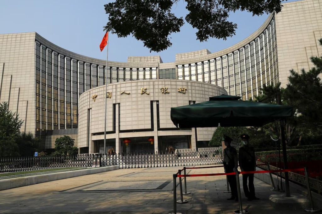 Paramilitary police officers stand guard in front of the headquarters of the People's Bank of China, the central bank (PBOC), in Beijing, China September 30, 2022. REUTERS