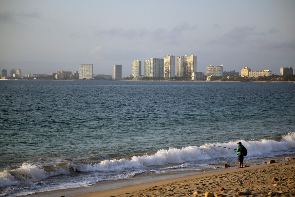 Photo by ALFREDO ESTRELLA / AFP  A man fishes on the coastline in Puerto Vallarta, Jalisco state, Mexico on February 24, 2026.