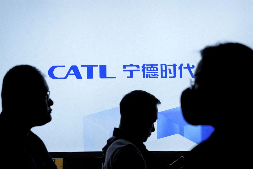 FILE PHOTO: People walk past a logo of the battery manufacturer Contemporary Amperex Technology Co. Limited (CATL) at the Auto Shanghai show, in Shanghai, China April 18, 2023. REUTERS/Aly Song/File Photo