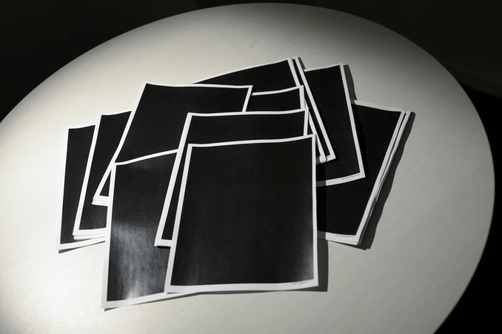 A sheaf of entirely redacted pages are seen among the Epstein documents. REUTERS/Jonathan Ernst