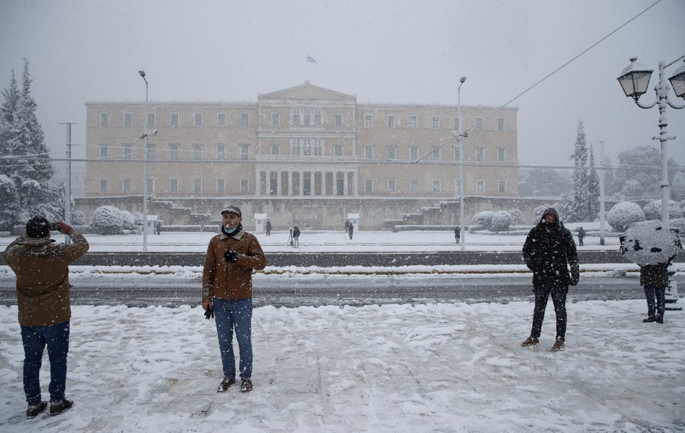 Snow falls in front of the Greek parliament in Athens, Tuesday. A cold weather front has hit Greece.