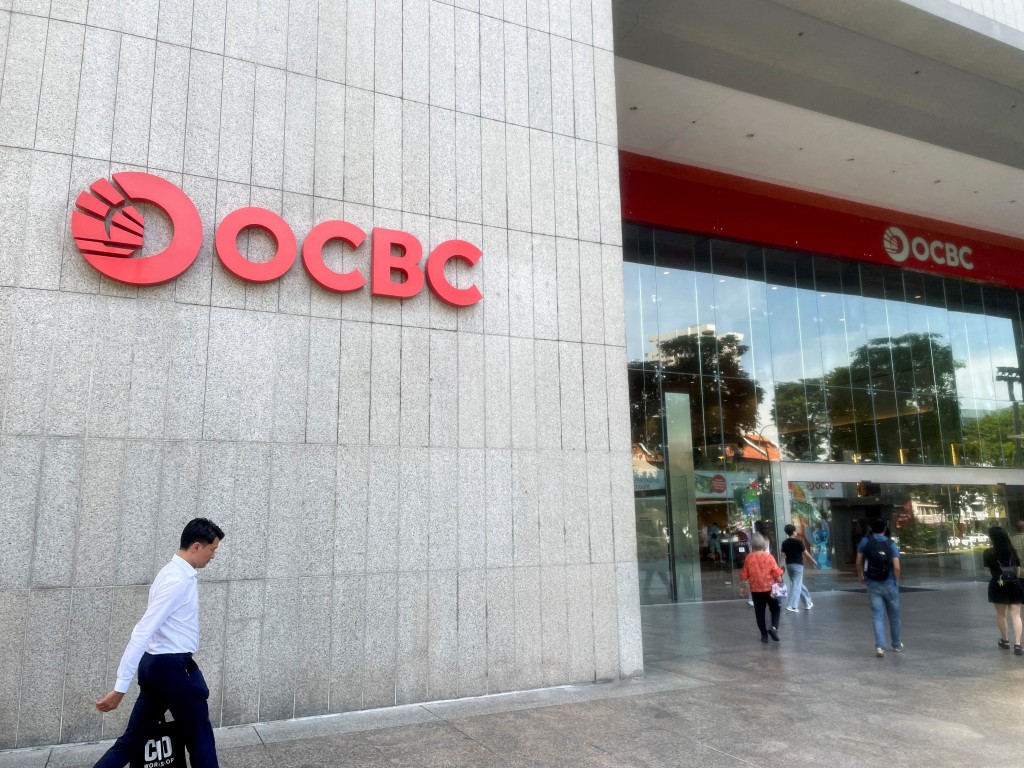 People walk in front of the Oversea-Chinese Banking Corp (OCBC) headquarters in Singapore, November 7, 2025. REUTERS