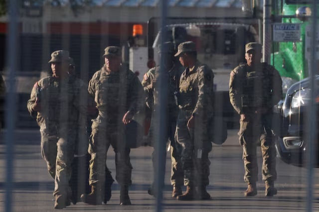 National Guard members walk at the U.S. Immigration and Customs Enforcement (ICE) Broadview facility in Chicago, Illinois, U.S., October 9, 2025. REUTERS/Jeenah Moon/File Photo