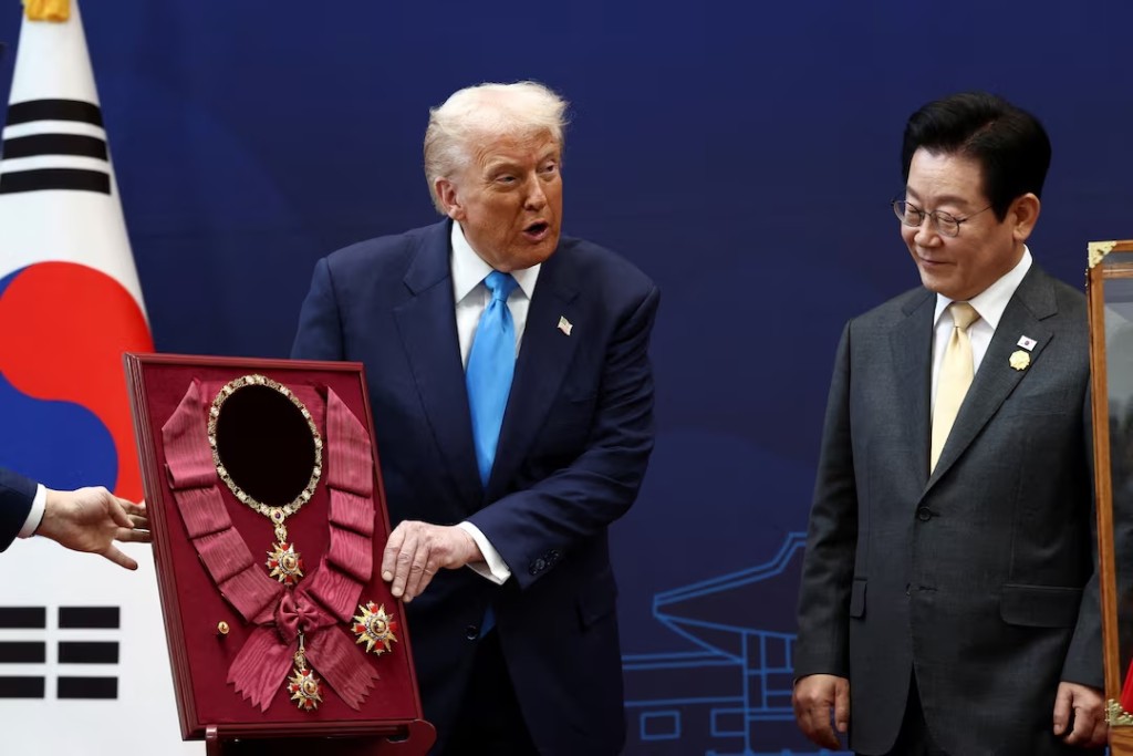 U.S. President Donald Trump is presented with the "Grand Order of Mugunghwa" during a meeting with South Korean President Lee Jae Myung on the sidelines of the Asia-Pacific Economic Cooperation (APEC) leaders' summit in Gyeongju, South Korea, October 29, 2025. REUTERS/Evelyn Hockstein
