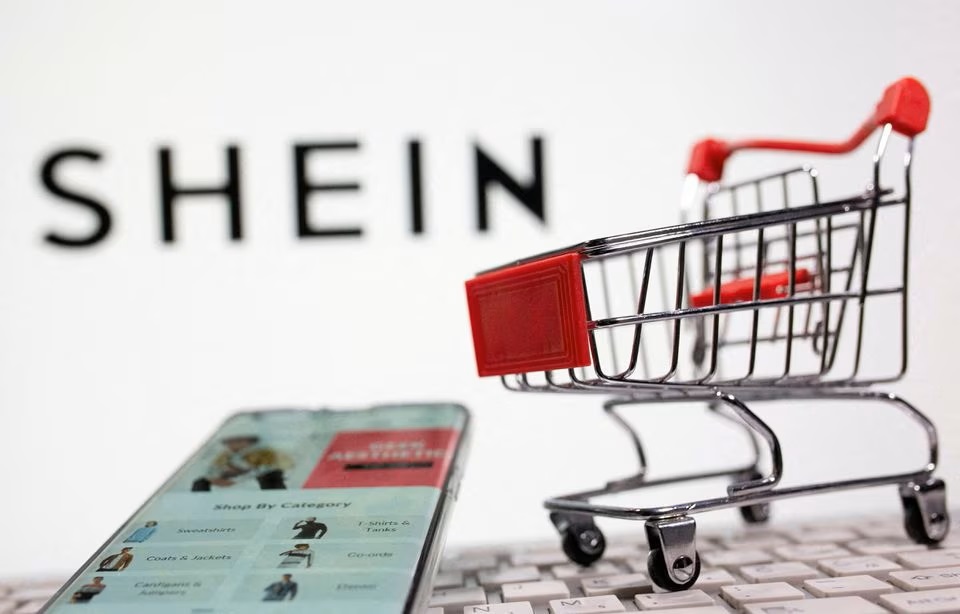 A keyboard and a shopping cart are seen in front of a displayed Shein logo in this illustration. (Reuters) A keyboard and a shopping cart are seen in front of a displayed Shein logo in this illustration. (Reuters)