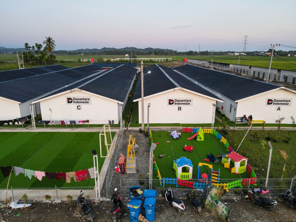 Photo by CHAIDEER MAHYUDDIN / AFP  An aerial view shows temporary housing built by Indonesian state-owned investment agency Danantara for flood survivors in Meureudu, Aceh province's Pidie Jaya district on February 22, 2026, after devastating floods and landslides struck Indonesia's Sumatra late last year.