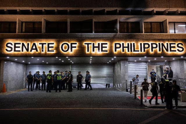 Police officers stand outside the Senate building, after gunshots were heard at the Philippine Senate, as chaos mounted in anticipation of an attempt to arrest a top senator wanted by the International Criminal Court, in Pasay City, Metro Manila, Philippines, May 13, 2026. REUTERS/Eloisa Lopez