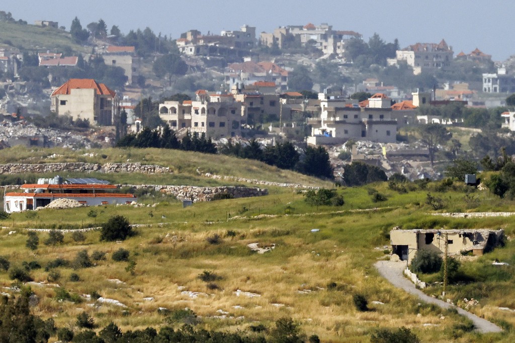 Photo by JALAA MAREY / AFP  Destroyed buildings are pictured in the village of Bint Jbeil in southern Lebanon as seen from across the border in the Upper Galilee region of northern Israel on May 13, 2026.
