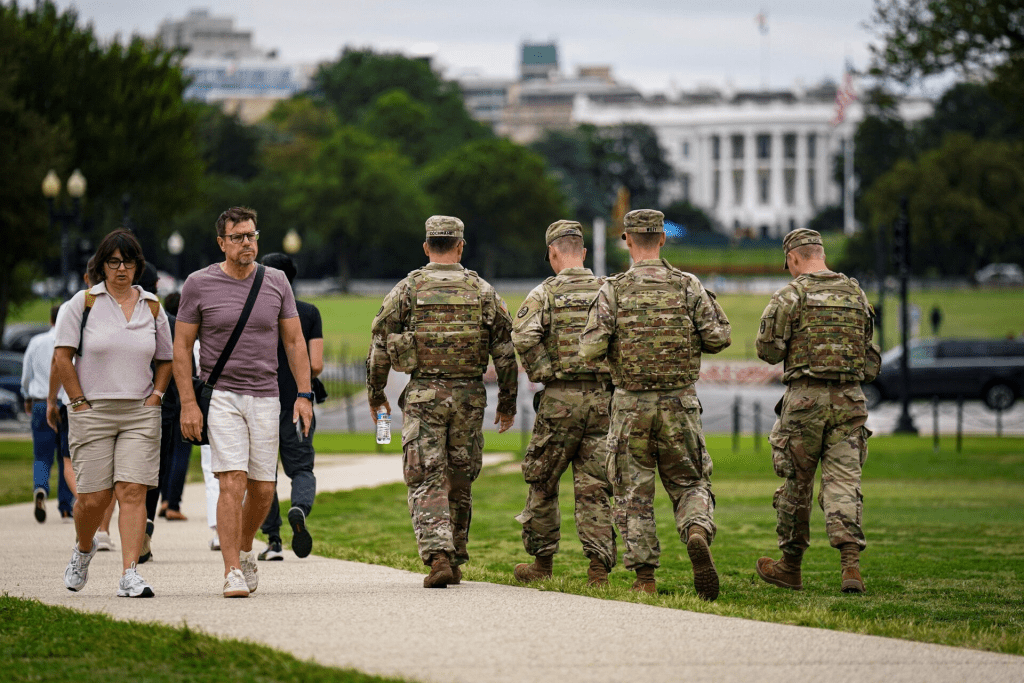 Members of the National Guard walk near the White House on the National Mall after U.S. President Donald Trump deployed the National Guard and ordered an increased presence of federal law enforcement to assist in crime prevention, in Washington, D.C., U.S., August 21, 2025. REUTERS/Al Drago