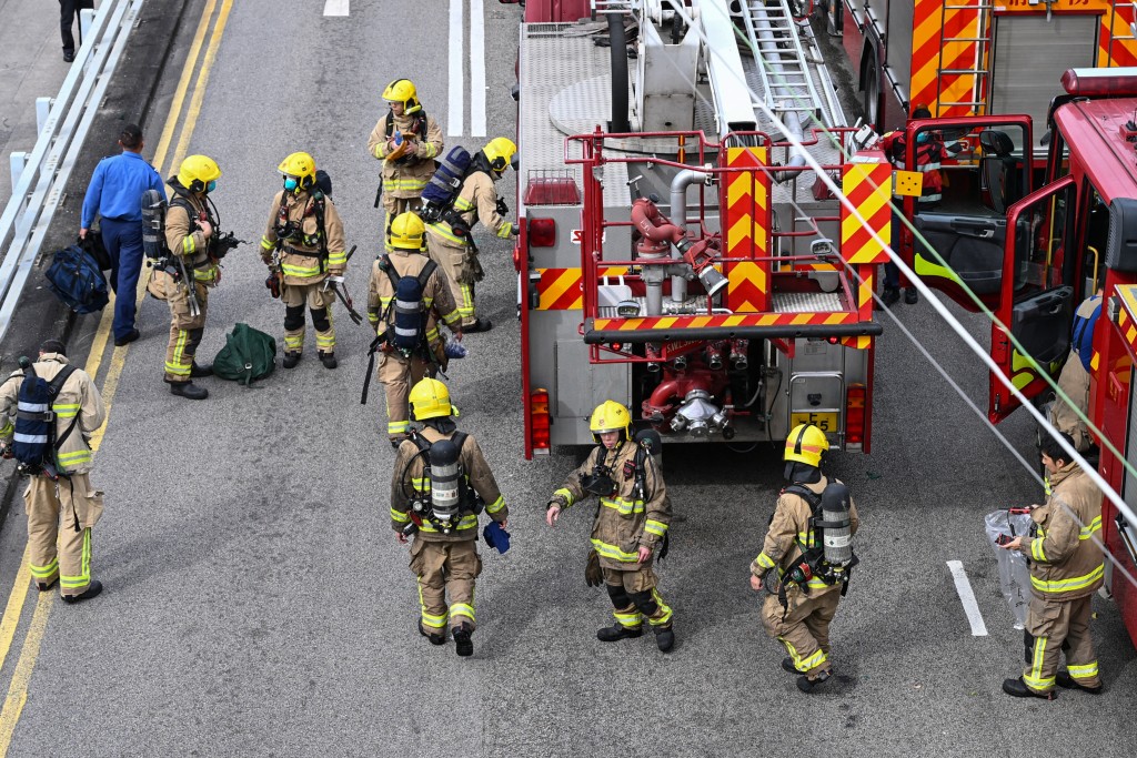 Photo by PETER PARKS / AFP  Firefighters prepare to enter the still burning Wang Fuk Court residential estate in Hong Kong's Tai Po district on November 27, 2025.
