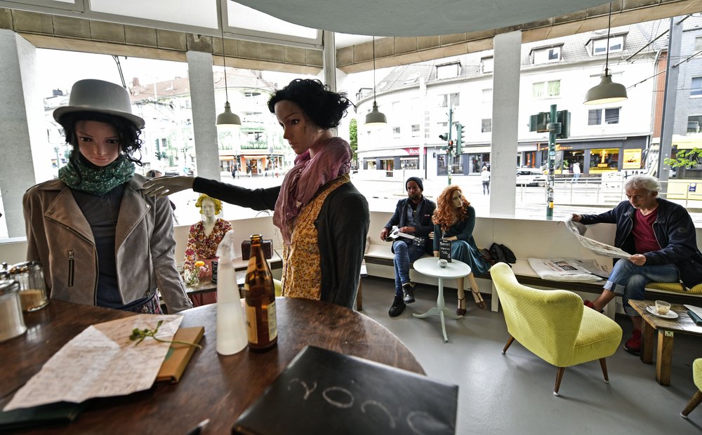 Display mannequins are placed between customers at the Cafe Livres in Essen, Germany, Wednesday, May 20.