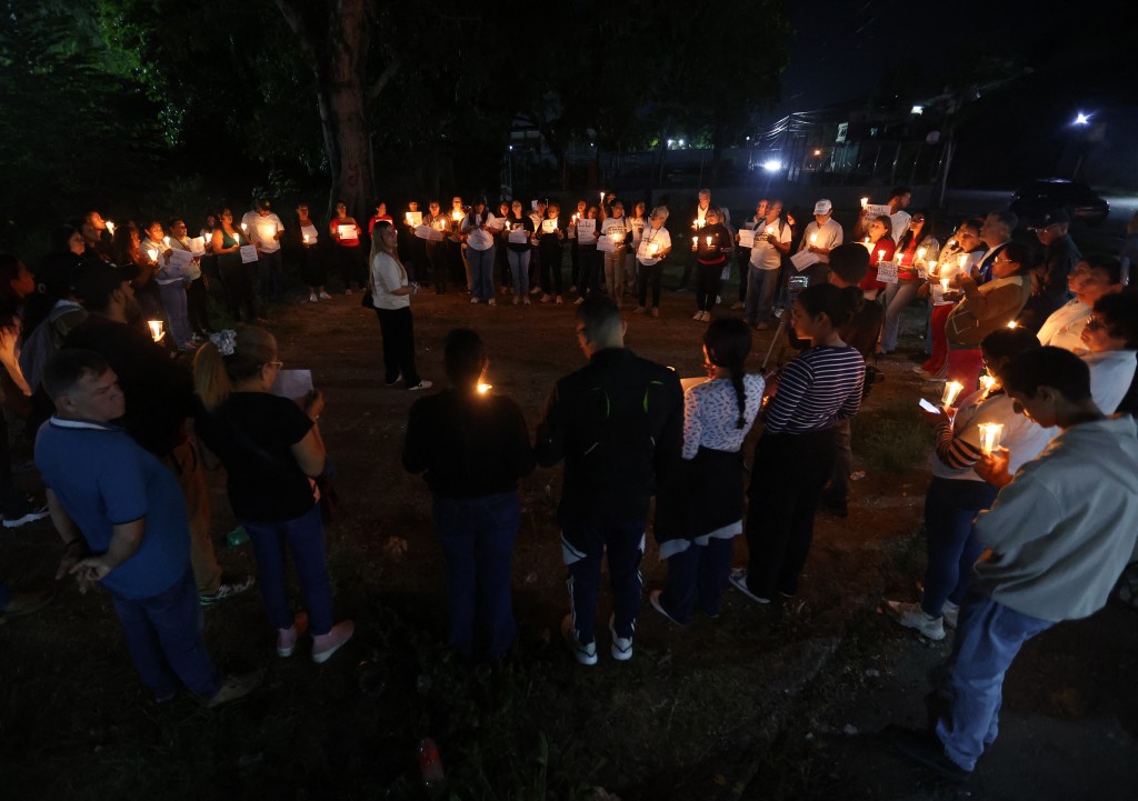Relatives of political prisoners lit candles during a vigil outside El Rodeo I prison in Guatire, Miranda State, some 30 kilometers east of Caracas on January 10, 2026. (AFP)