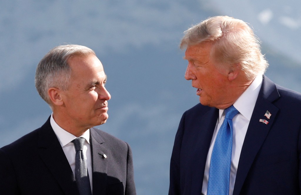 U.S. President Donald Trump and Canada's Prime Minister Mark Carney talk during a family photo at the G7 Summit in Kananaskis, Alberta, Canada, June 16, 2025. (Reuters)