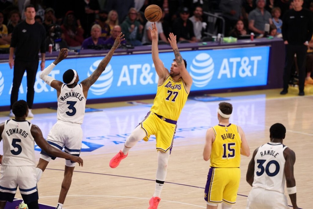  Los Angeles Lakers guard Luka Doncic (77) shoots the ball over Minnesota Timberwolves forward Jaden McDaniels (3) during the third quarter of game. (Reuters)
