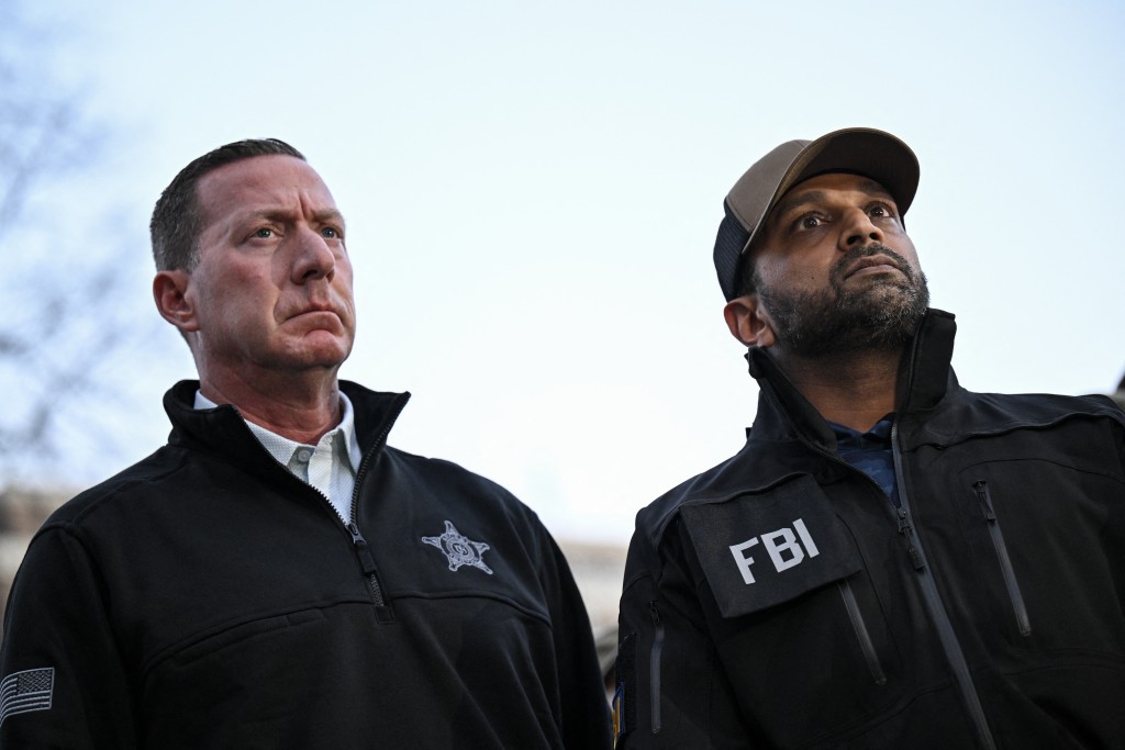 Photo by DREW ANGERER / AFP  FBI Director Kash Patel (R) and the US Secret Service Director Sean Curran look on during a press conference after a shooting in downtown Washington, DC, on November 26, 2025.