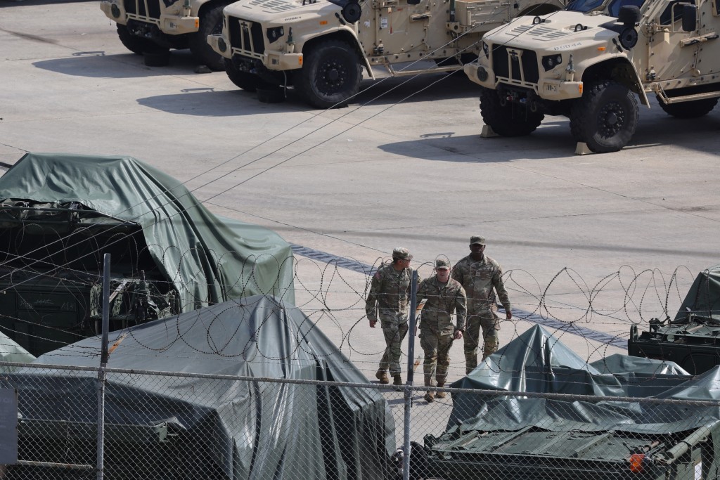 Photo by - / YONHAP / AFP  Military vehicles covered with tarps are parked at a US Army base in Dongducheon on August 18, 2026.