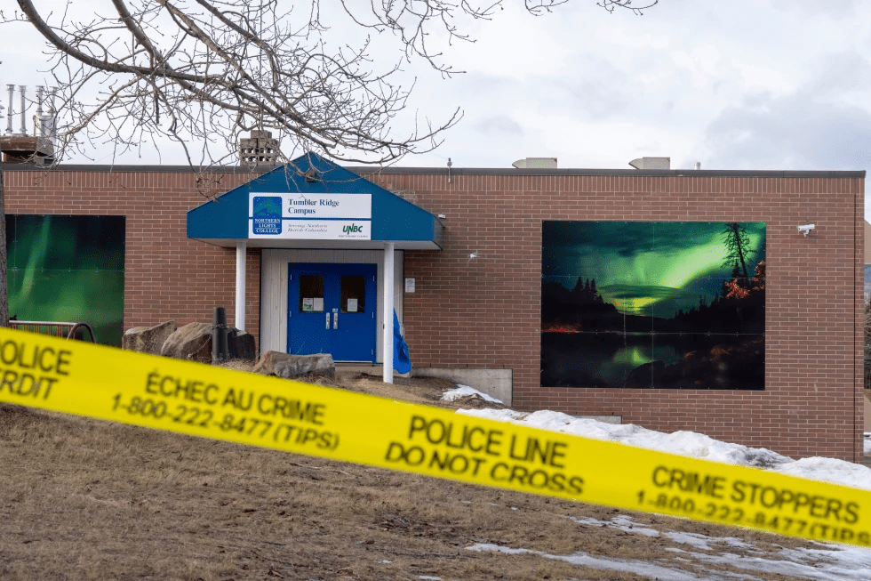 Police tape surrounds a school in Tumbler Ridge, British Columbia, Canada, on Thursday, Feb. 12, 2026, after Tuesday's mass shooting. (Christinne Muschi/The Canadian Press via AP)