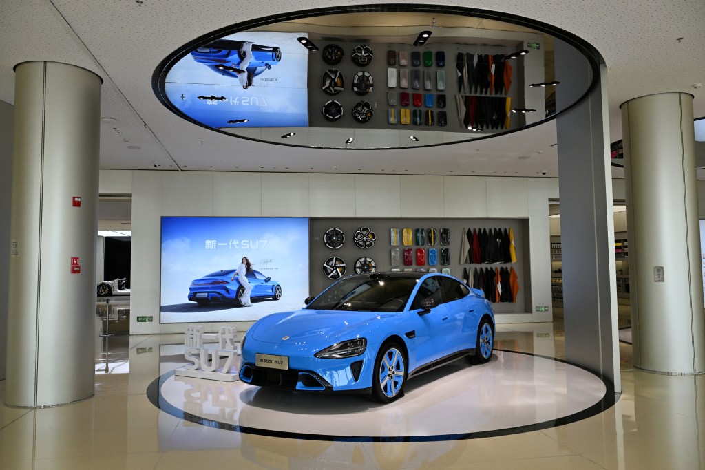 A Xiaomi SU7 car is displayed at the gallery of the company's headquarters in Beijing on April 22, 2026. (Photo by Adek BERRY / AFP)