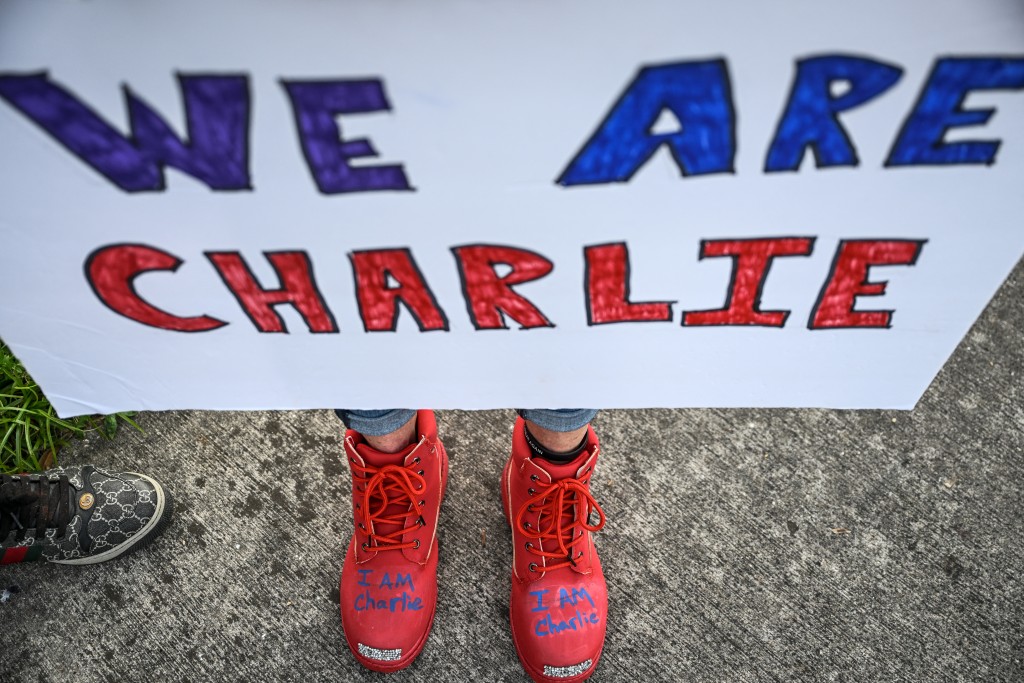 A supporter of right-wing activist Charlie Kirk rallies outside the School District Welcome Center as a school board meeting is taking place in West Palm Beach, Florida, on October 15, 2025. (Photo by CHANDAN KHANNA / AFP)