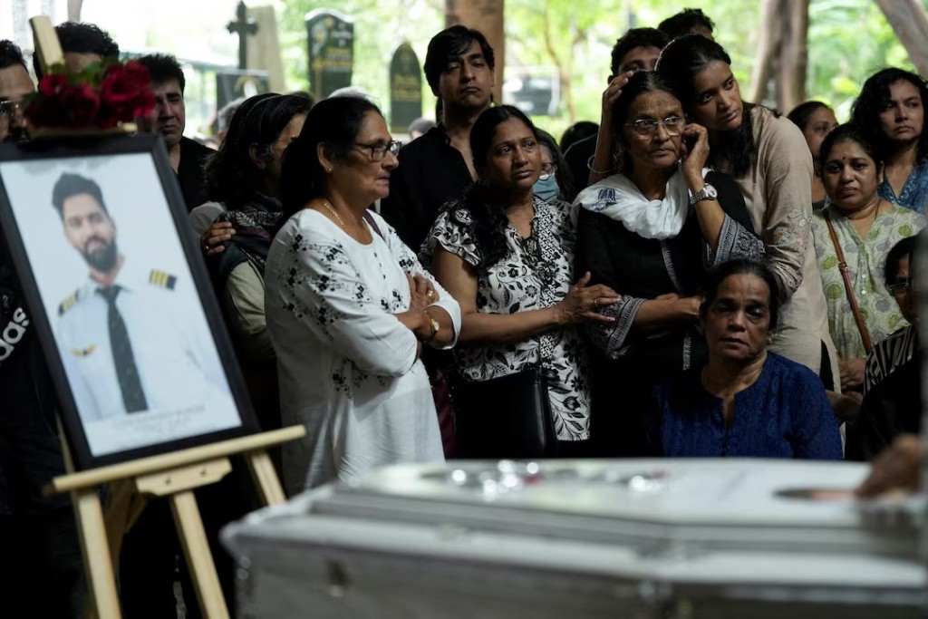 Friends and family members mourn near the coffin of Co-Pilot Clive Kunder, who died after an AIR India Boeing 787-8 Dreamliner plane crashed during take-off from an airport in Ahmedabad, in Mumbai, India June 19, 2025. REUTERS/Hemanshi Kamani/File Photo