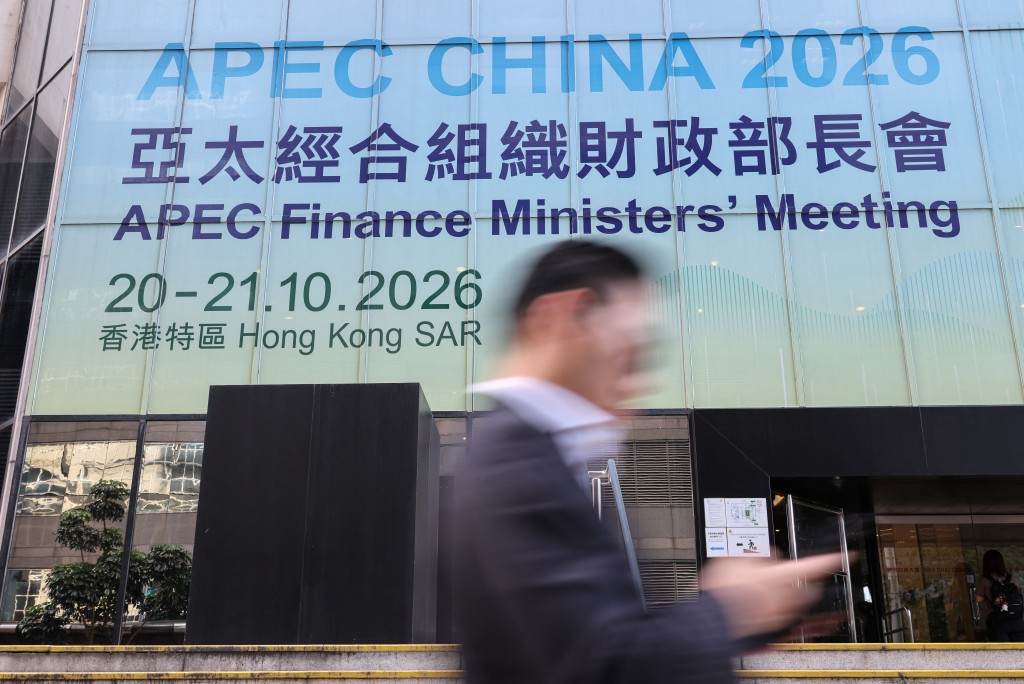 A man walks past a sign for the APEC Finance Ministers' Meeting in Hong Kong, China, October 20, 2026. REUTERS