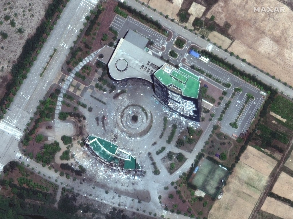 Photo by HANDOUT / SATELLITE IMAGE ©2020 MAXAR TECHNOLOGIES / AFP  This handout satellite image released by Maxar Technologies shows the close up view of north-south joint liaison office and administration building on June 22, 2020, after it was intentionally destroyed by explosives set by North Korean forces on June 16.