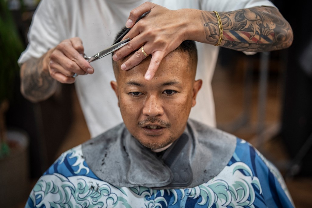 Photo by YUICHI YAMAZAKI / AFP  This photo taken on August 27, 2026 shows Tekisasu, an active yakuza gangster allied to a major clan, having his hair cut at a barbershop in Tokyo.