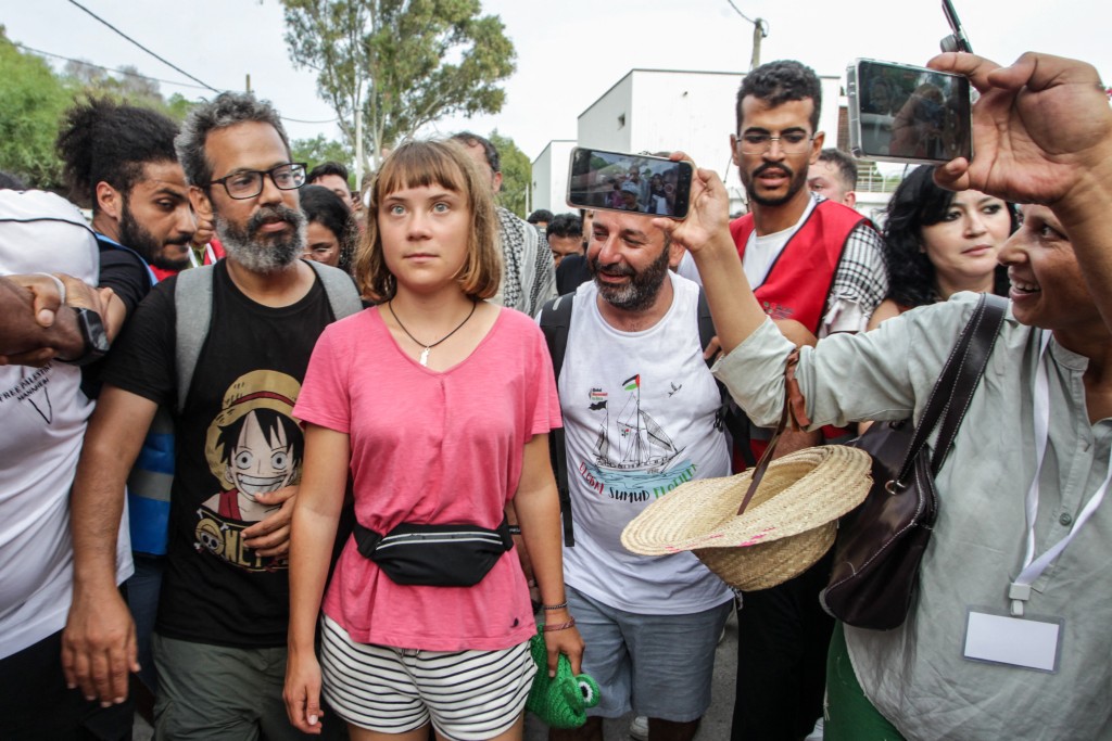 Swedish climate activist Greta Thunberg walks with a crowd of pro-Palestinian activists that arrived to greet the Global Sumud Flottila at the port of the village of Sidi Bou Said on September 7, 2025.  (Photo by Yassine Mahjoub / AFP)
