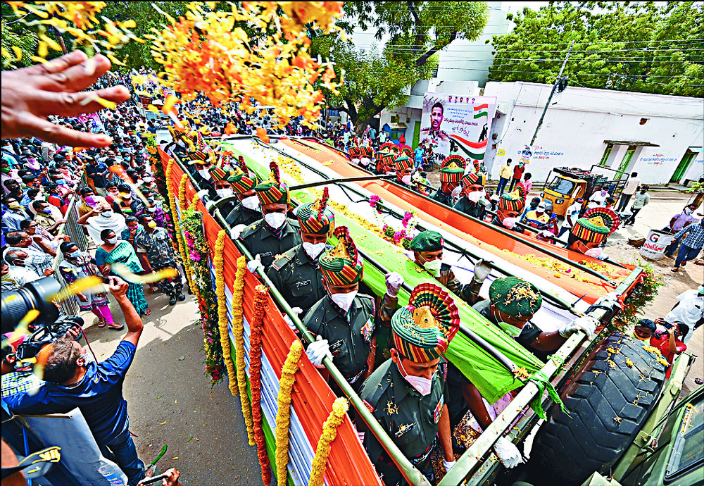 The military truck bearing the coffin of Colonel B Santosh Babue is showered with flower petals at his hometown of Suryapet. REUTERS The military truck bearing the coffin of Colonel B Santosh Babue is showered with flower petals at his hometown of Suryapet. REUTERS