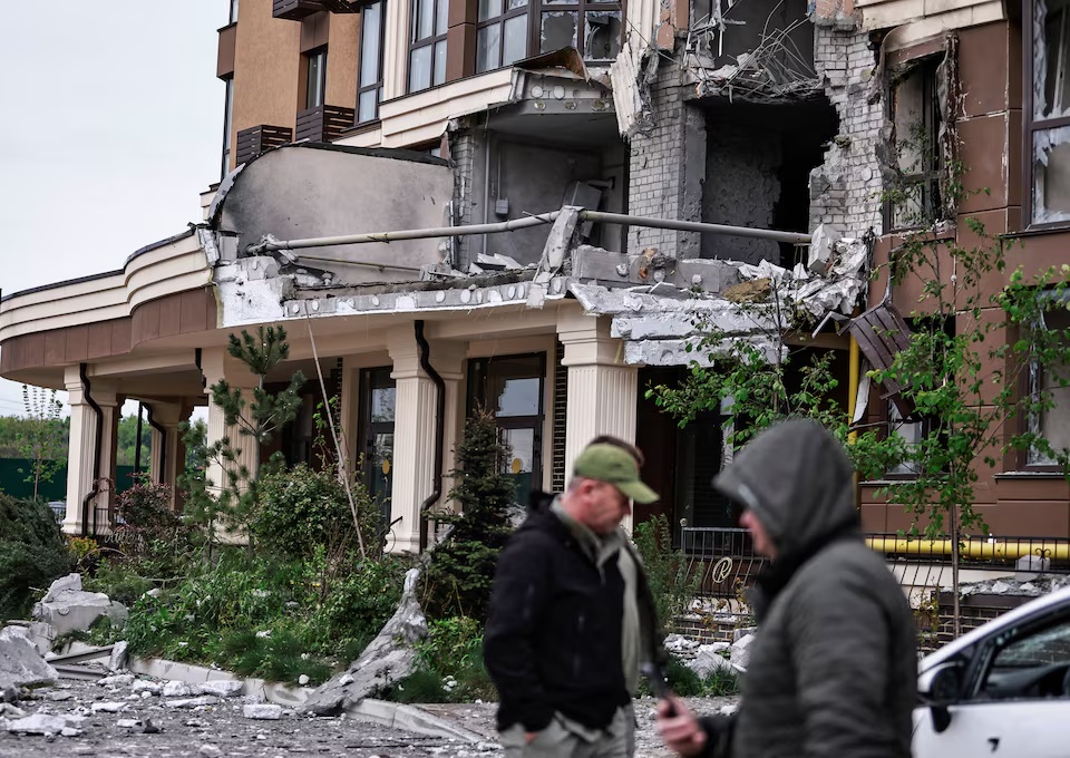 Residents walk near the building hit by a Russian drone strike, amid Russia's attack on Ukraine, on the outskirts of Kyiv, Ukraine May 7, 2025. REUTERS/Yan Dobronosov