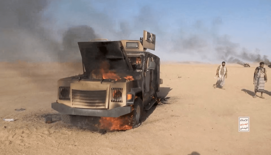 Iran-aligned Houthi fighters move next to a destroyed vehicle following what the source described as an attack on Saudi-backed forces in the location given by the source as al Jawf governorate, Yemen, in this screengrab taken from a video released by Houthi Military Media on September 15, 2026. HOUTHI MILITARY MEDIA/Handout via REUTERS.