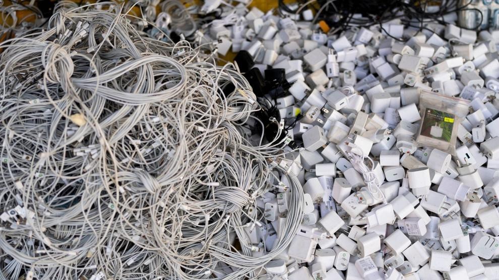 FILE -Used charging cables and power adapters are piled up at a shop in Nhat Tao market, the largest informal recycling market in Ho Chi Minh City, Vietnam, Jan. 28, 2024. - AP