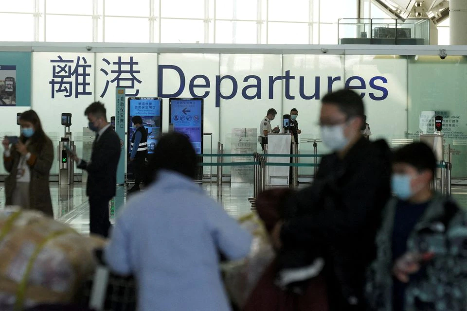 Passengers wearing face masks stand at the departures hall of Hong Kong International Airport. (Reuters) Passengers wearing face masks stand at the departures hall of Hong Kong International Airport. (Reuters)