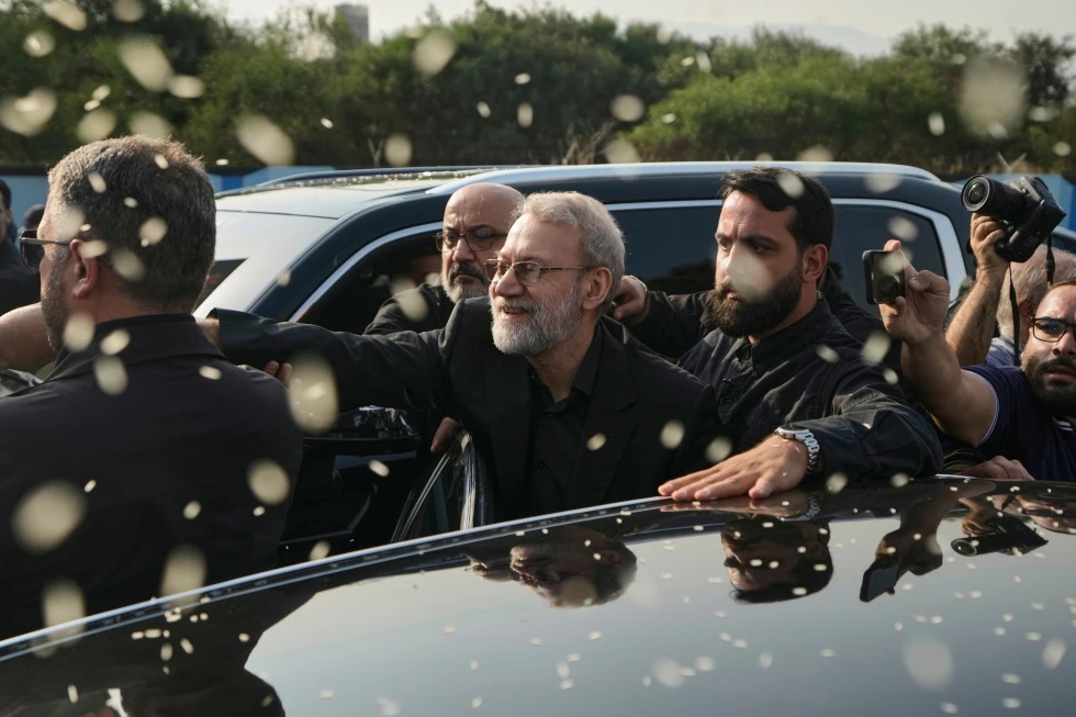 Ali Larijani, center, secretary of Iran's Supreme National Security Council, gestures as Hezbollah supporters throw rice to welcome him outside Rafik Hariri International Airport in Beirut, Lebanon, Wednesday, Aug. 13, 2025. (AP Photo/Bilal Hussein, File)