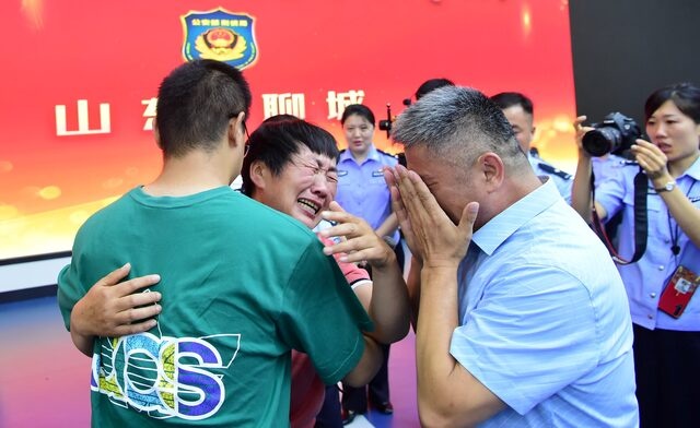 Guo Gangtang, 51, and his wife reunite with their son Guo Xinzhen, who was abducted 24 years ago at the age of 2, at a family reunion arranged by the police, in Liaocheng, Shandong province, China July 11, 2021. China Daily via REUTERS 