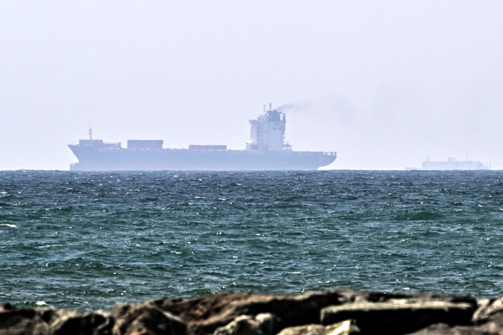 Photo by - / AFP Vessels are seen off the coast of Sharjah in the United Arab Emirates on May 21, 2026.