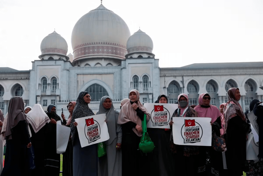 Muslim women hold placards as they stand in protest outside the Palace of Justice on the day the country's federal court delivers verdict in a constitutional case challenging the legality of some Islamic laws in Kelantan state, in Putrajaya, Malaysia February 9, 2024. REUTERS/Hasnoor Hussain Muslim women hold placards as they stand in protest outside the Palace of Justice on the day the country's federal court delivers verdict in a constitutional case challenging the legality of some Islamic laws in Kelantan state, in Putrajaya, Malaysia February 9, 2024. REUTERS/Hasnoor Hussain