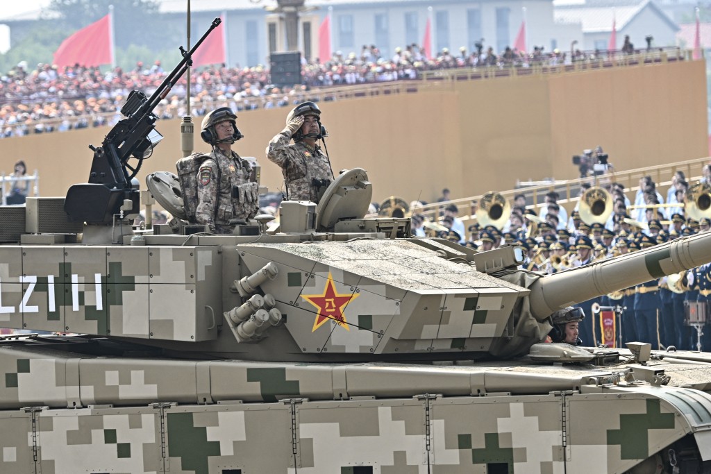 Officers are seen in the hatch of a Type 99 main battle tank as it roll during a military parade marking the 80th anniversary of victory over Japan and the end of World War II, in Beijing’s Tiananmen Square on September 3, 2025. (AFP)