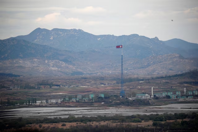 A North Korean flag flutters on top of a 160-metre tower in North Korea's propaganda village of Gijungdong, in this picture taken from the Dora observatory near the demilitarised zone separating the two Koreas, in Paju, South Korea, April 24, 2018. REUTERS/Kim Hong-Ji/File Photo