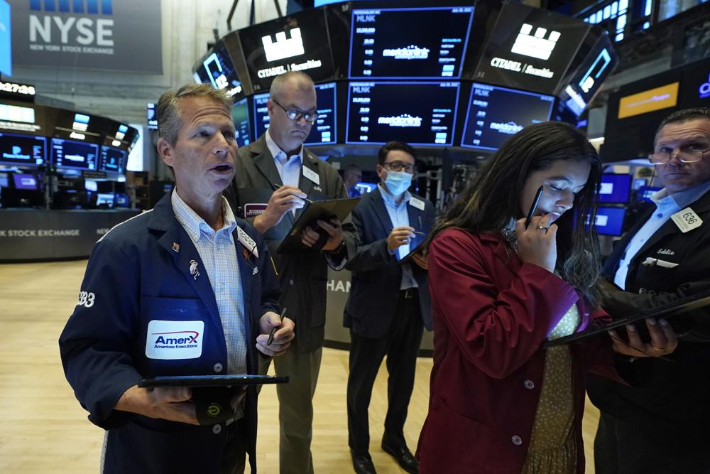 Robert Charmak, left, works with fellow traders on the floor of the New York Stock Exchange, Wednesday, July 28, 2021. Global stock markets were mixed Wednesday after Wall Street pulled back from a record as investors awaited a Federal Reserve report for signs of when U.S. stimulus might be withdrawn. Robert Charmak, left, works with fellow traders on the floor of the New York Stock Exchange, Wednesday, July 28, 2021. Global stock markets were mixed Wednesday after Wall Street pulled back from a record as investors awaited a Federal Reserve report for signs of when U.S. stimulus might be withdrawn.