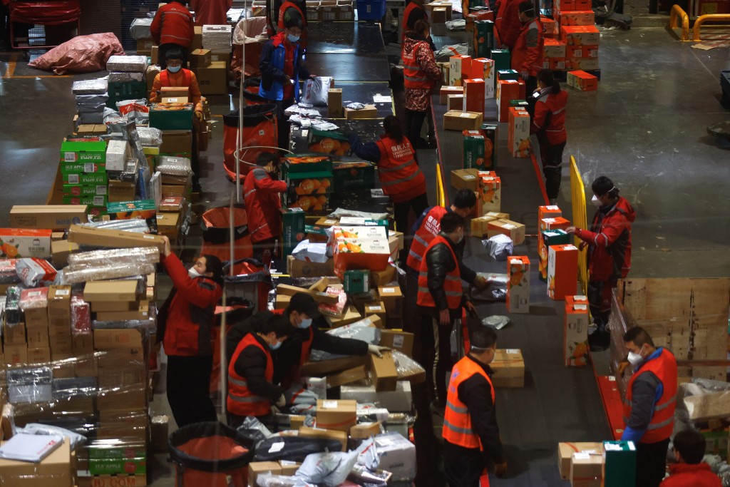 Employees sort packages during an organised media tour at Asia No.1 logistics centre of JD Logistics by JD.com in Beijing, China January 10, 2023. REUTERS/Tingshu Wang