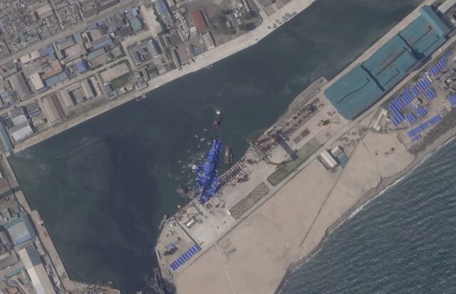 A satellite image shows a North Korean warship covered with a blue tarp after an accident that occurred during its launch at the shipyard in Chongjin, North Korea, May 24, 2025. 2025 Planet Labs PBC/Handout via REUTERS/File Photo 
