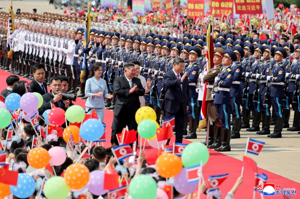 Photo by STR / KCNA VIA KNS / AFP  This picture taken on June 9, 2026 and released by North Korea's official Korean Central News Agency (KCNA) on June 10, 2026 shows North Korean leader Kim Jong Un (centre L) and his wife Ri Sol Ju (L) seeing off China's President Xi Jinping (centre R) and his wife Peng Liyuan during the latter's departure from Pyongyang International Airport.