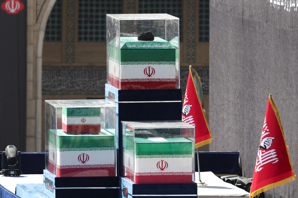 A turban is placed over the coffin of Iran's late Supreme Leader Ayatollah Ali Khamenei, near the coffins of Khamenei's family members in the colours of Iranian flags on the stage, as people gather for a public farewell ceremony to pay their respects to late Supreme Leader Ayatollah Ali Khamenei (Reuters)
