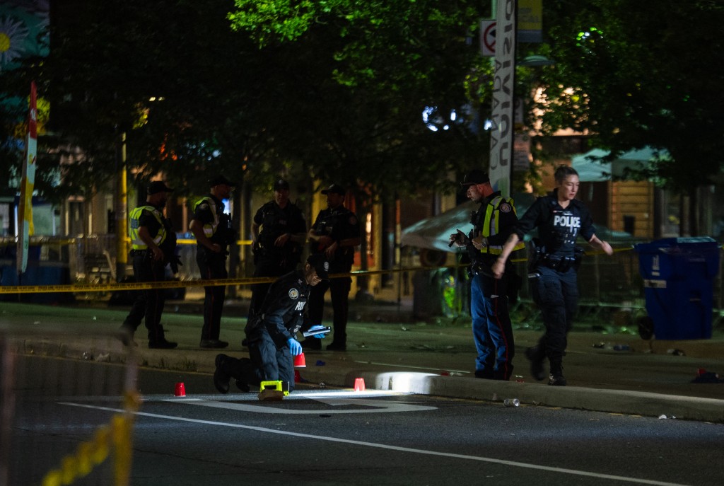 Police officers investigate the site of a shooting that occurred at the Salsa on St. Clair Festival in Toronto on the evening of July 11, 2026. (AFP)